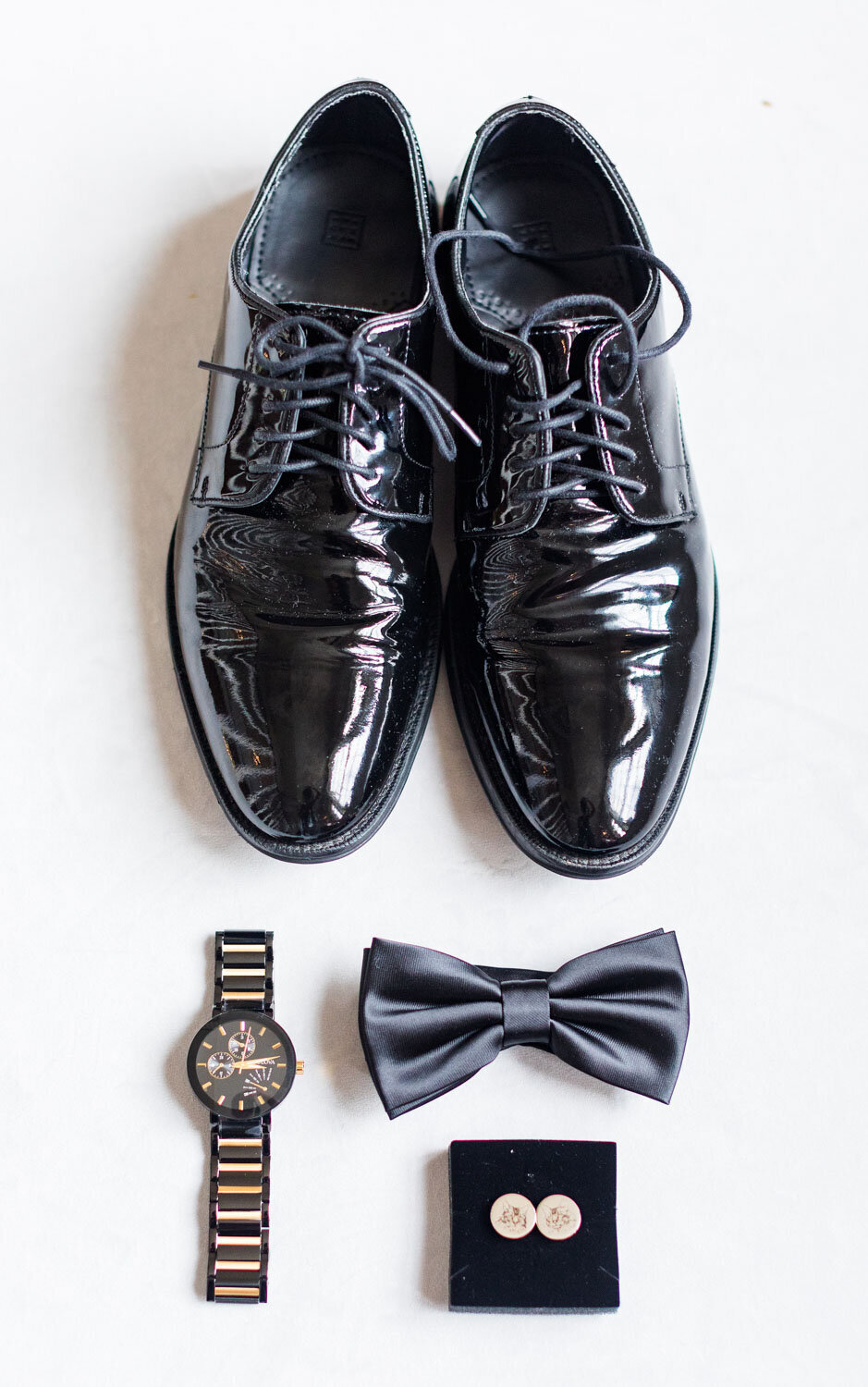 Flat lay of grooms wedding details