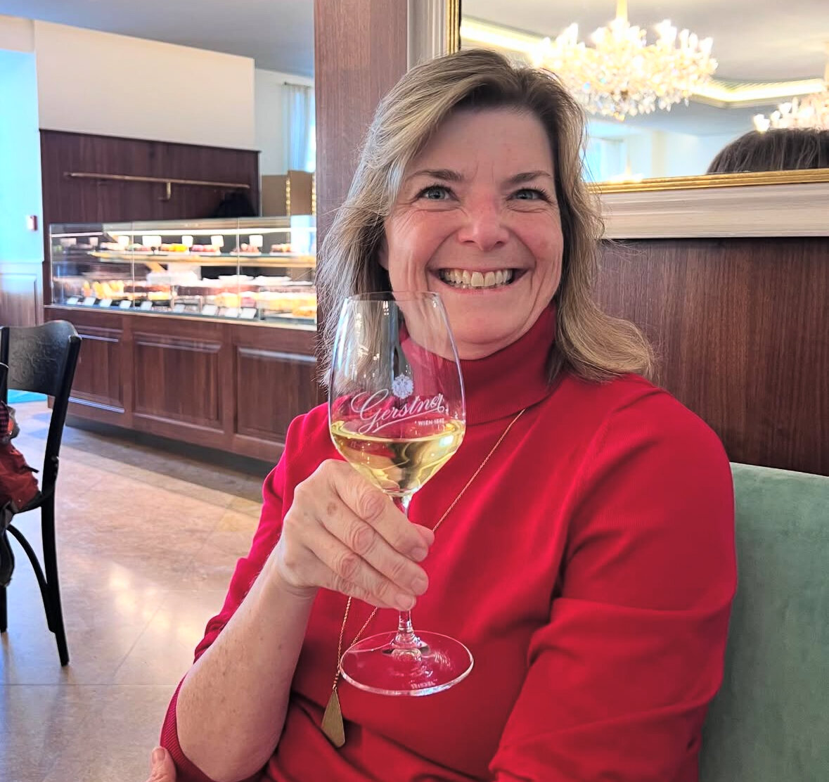 Kelly with a glass of wine at a restaurant