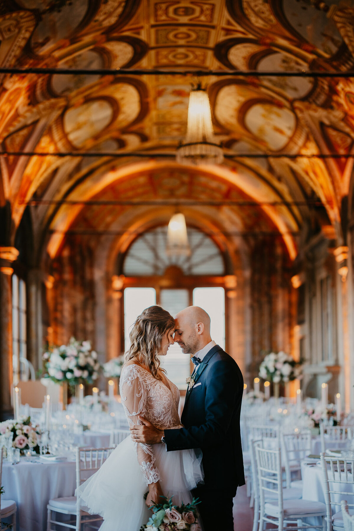 Bride and groom in frescoed hall during elegant reception at Villa Corsini Mezzomonte, wedding photographer Tuscany Florence.