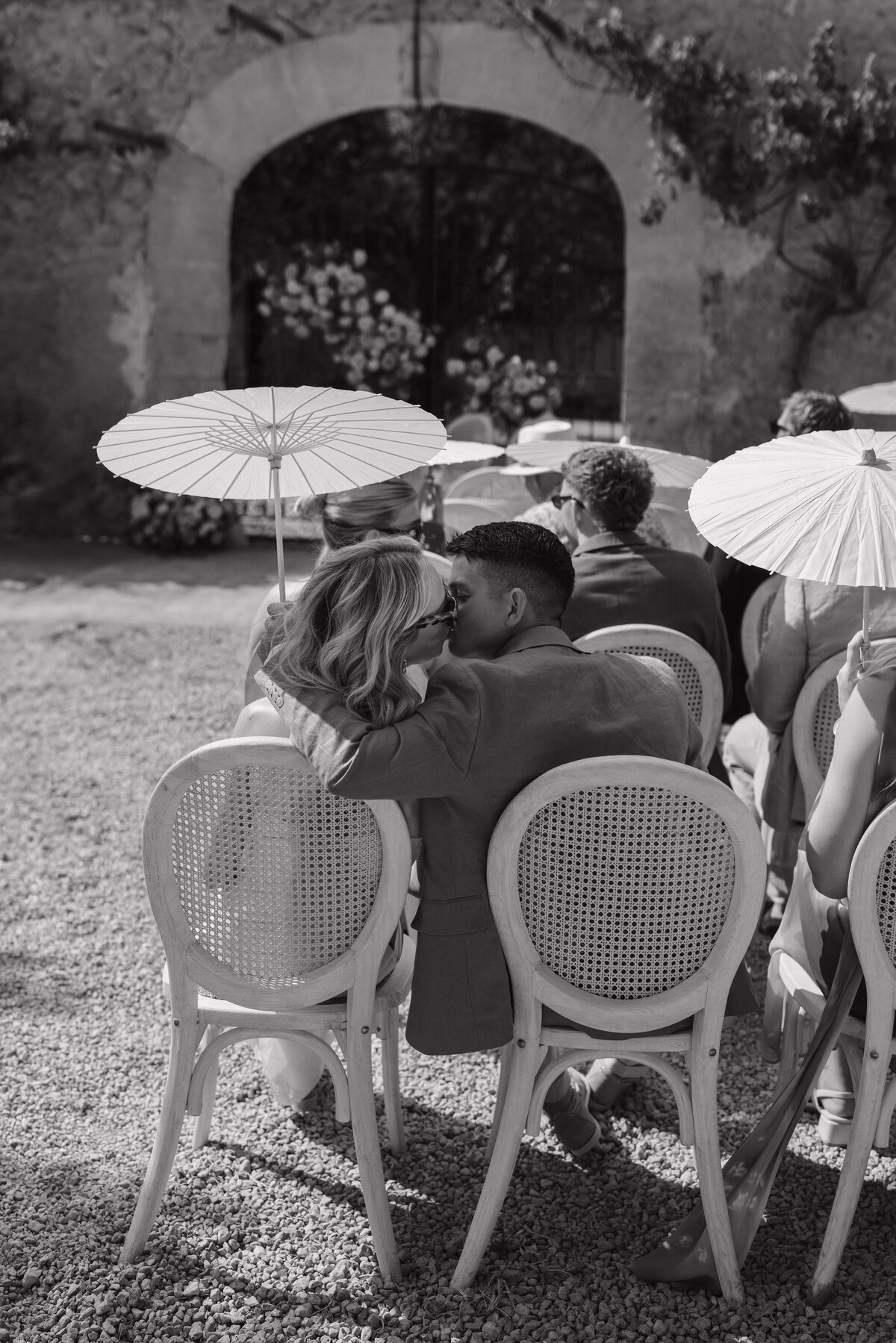 Wedding photographer captures couple taking a stroll hand in hand at their french chateau wedding.