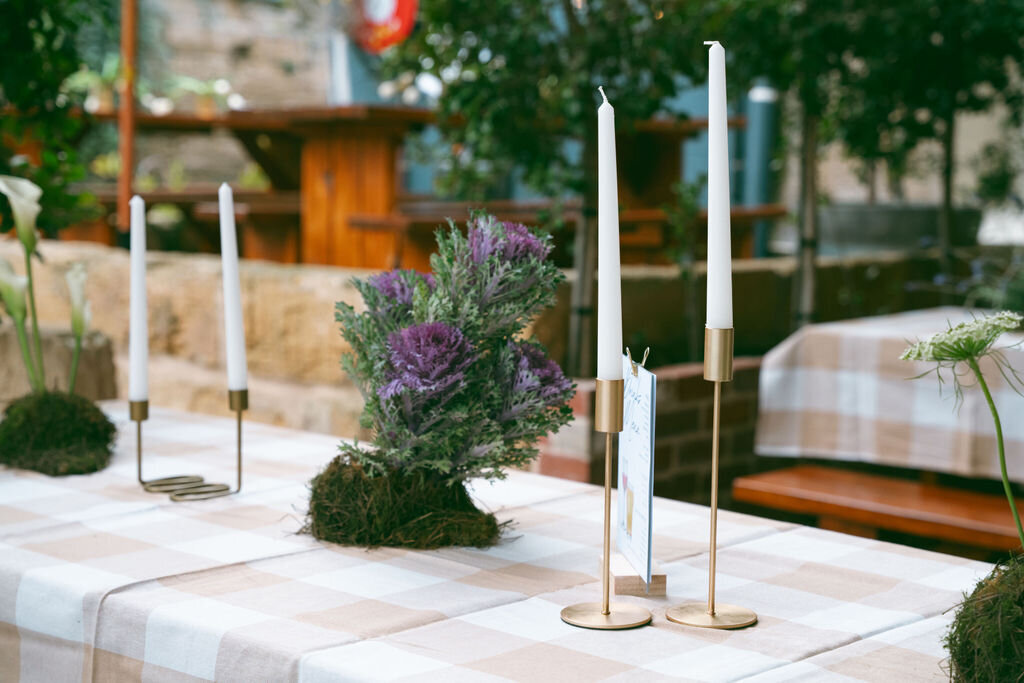 wedding table, gold taper candle holders, purple flowers