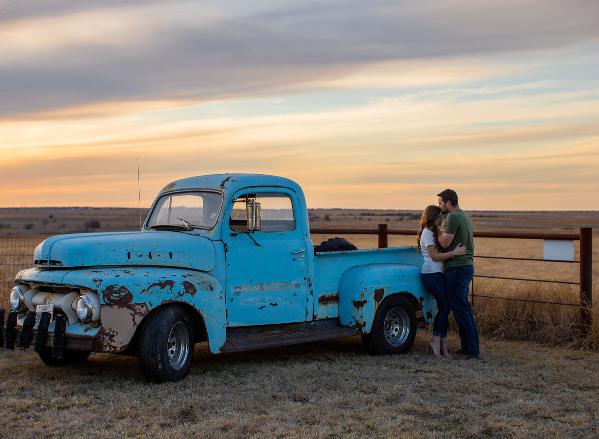 couple with classic truck at sunset