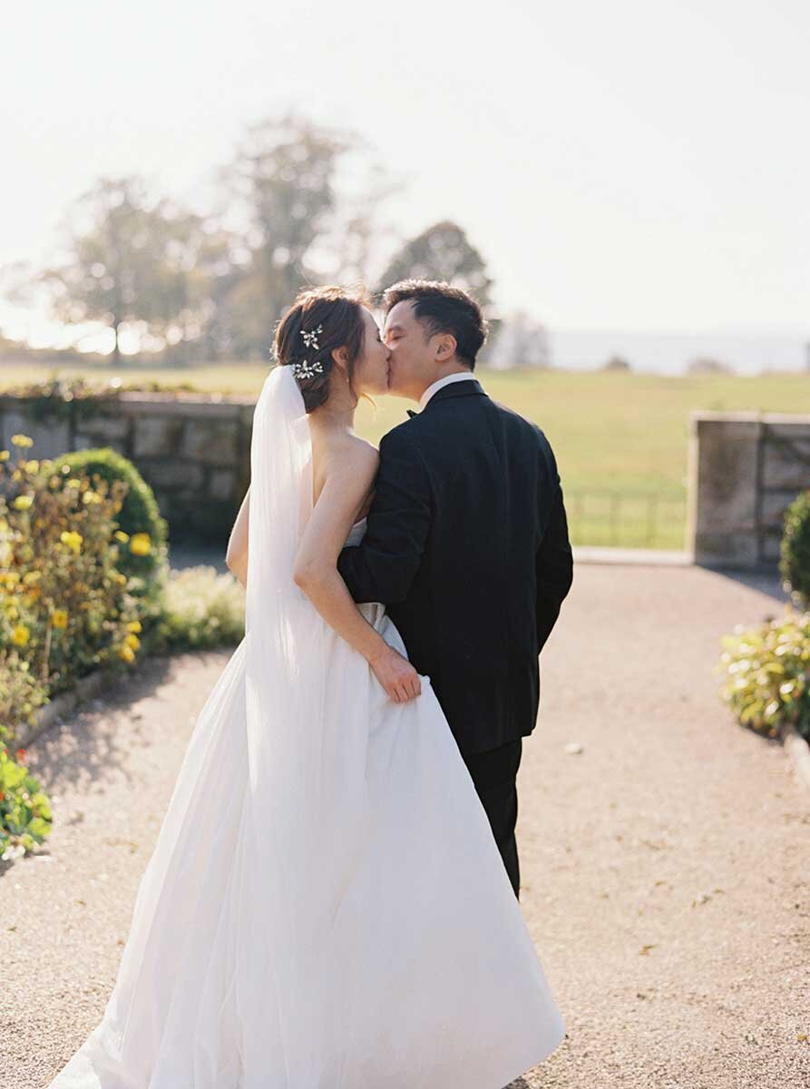 Bride and groom walking in Eolia Mansion garden