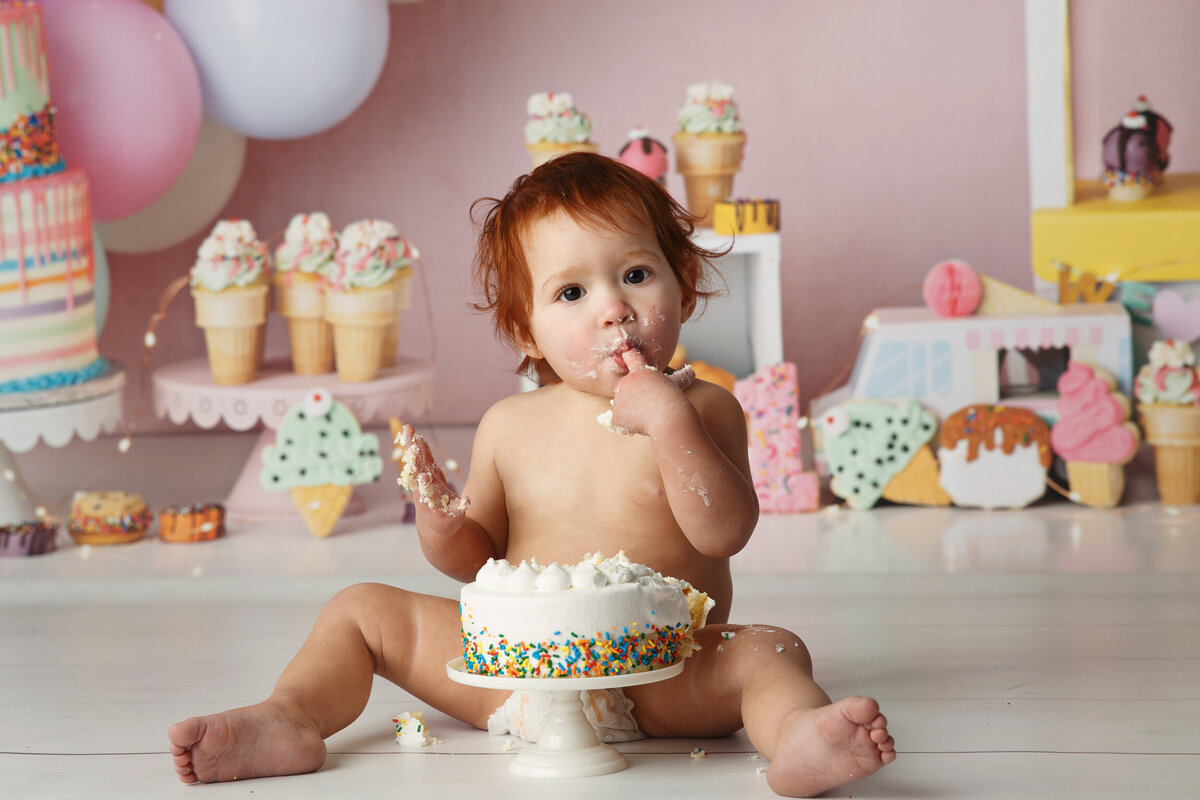 One Year old cake smash session photographed on a sweet tree background by baby photographer at Life in Pink Photography