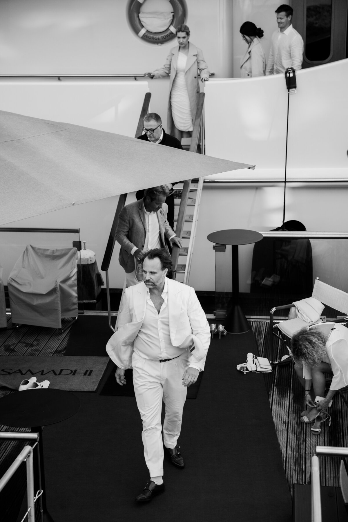 Guests elegantly descend the stairs of the Samadhi yacht during an exclusive event at the Scheepvaartmuseum, Amsterdam. The black-and-white photography enhances the sophistication and style of the gathering, perfect for luxury event coverage.