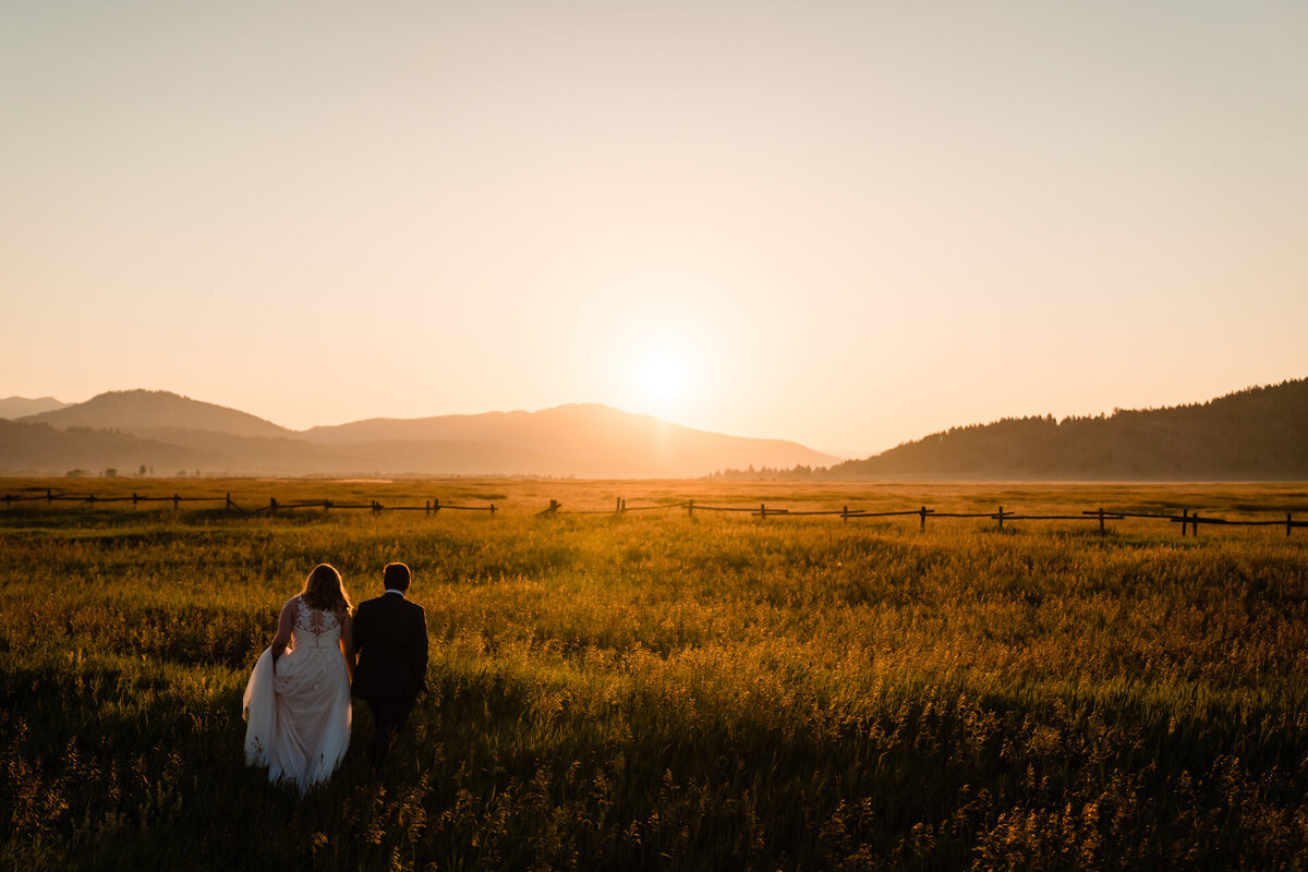 JD Land of sonderland.us captures a beautiful sunrise photograph of a couple during their Yellowstone and Grand Teton elopement wedding