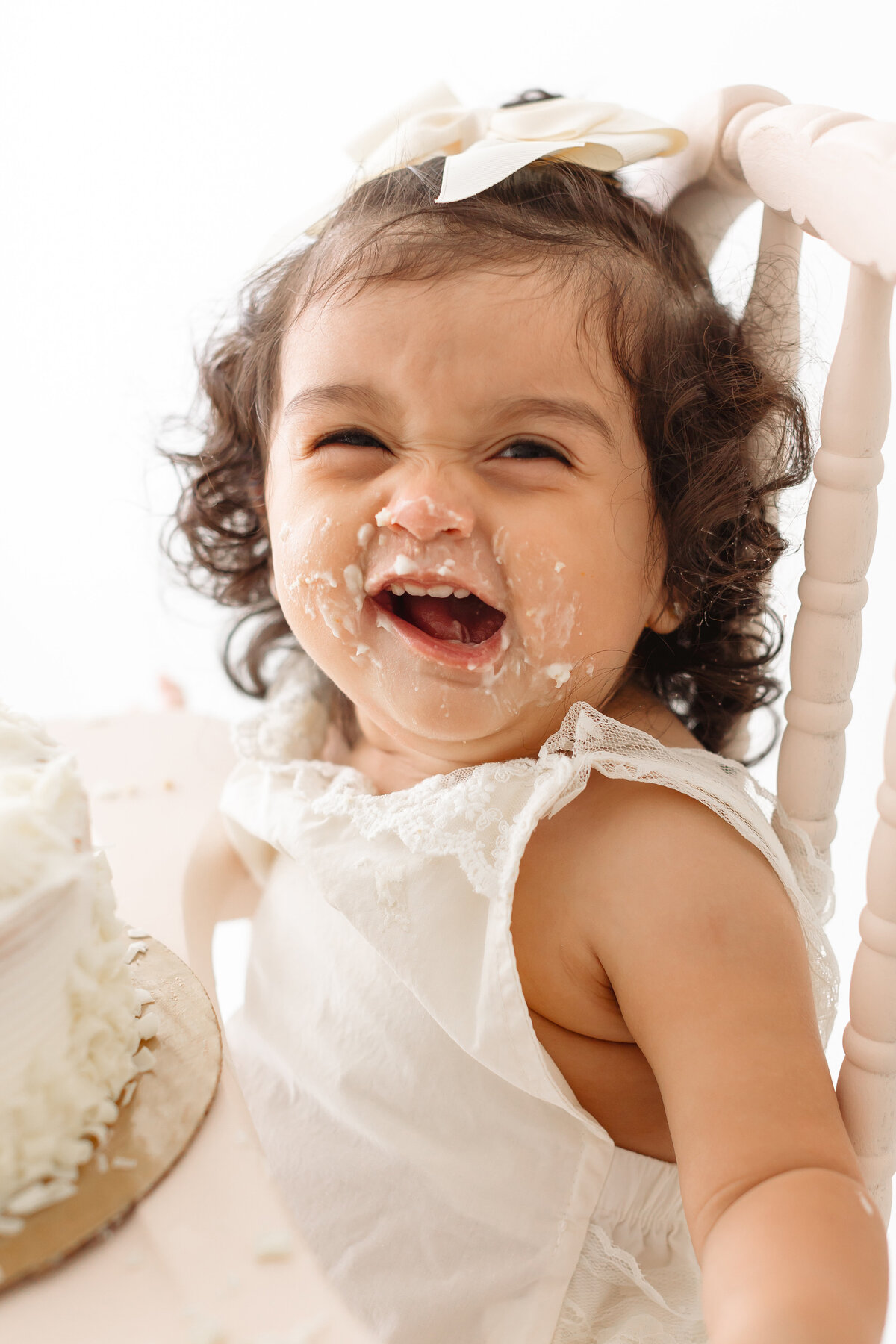 toddler smiling with frosting on face
