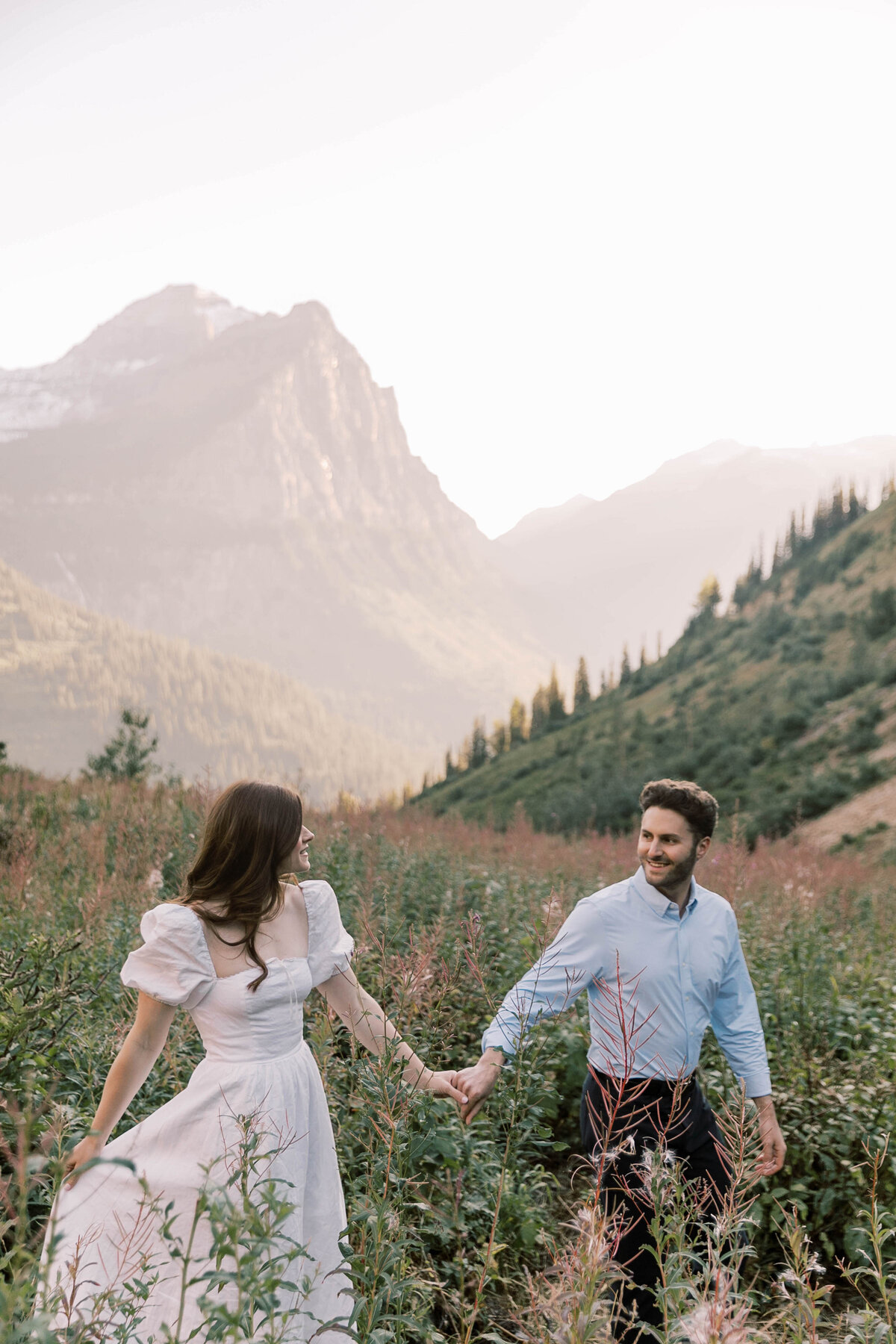 couple holding hands in field