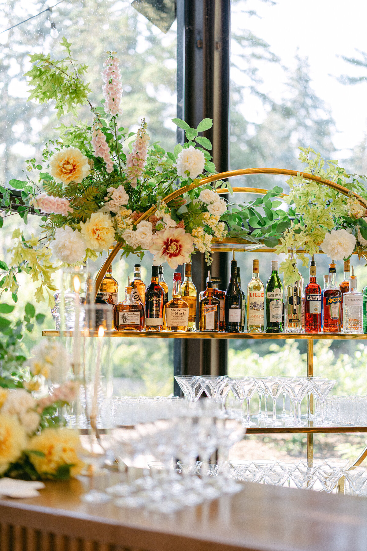 A lush arrangement of spring flowers sits on a barback at a La Toundra wedding reception.