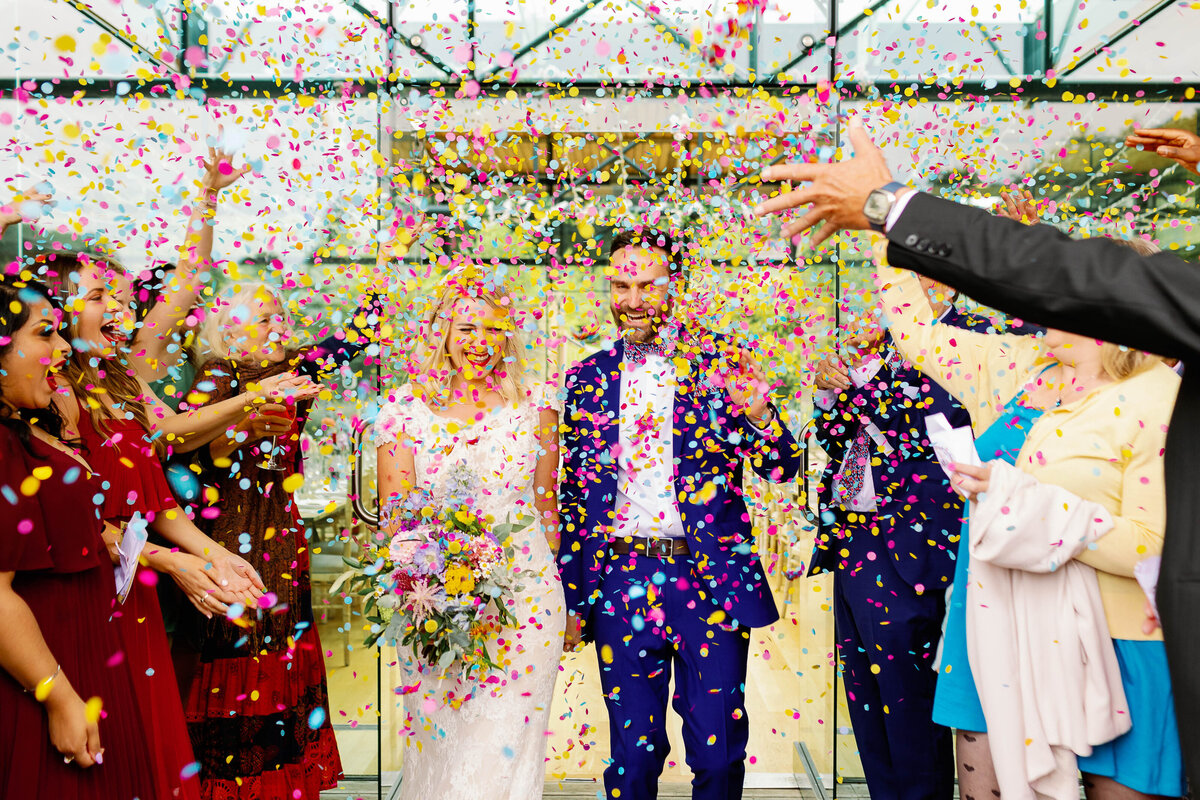Bride and groom showered in colourful confetti at Utopia, Broughton Sanctuary