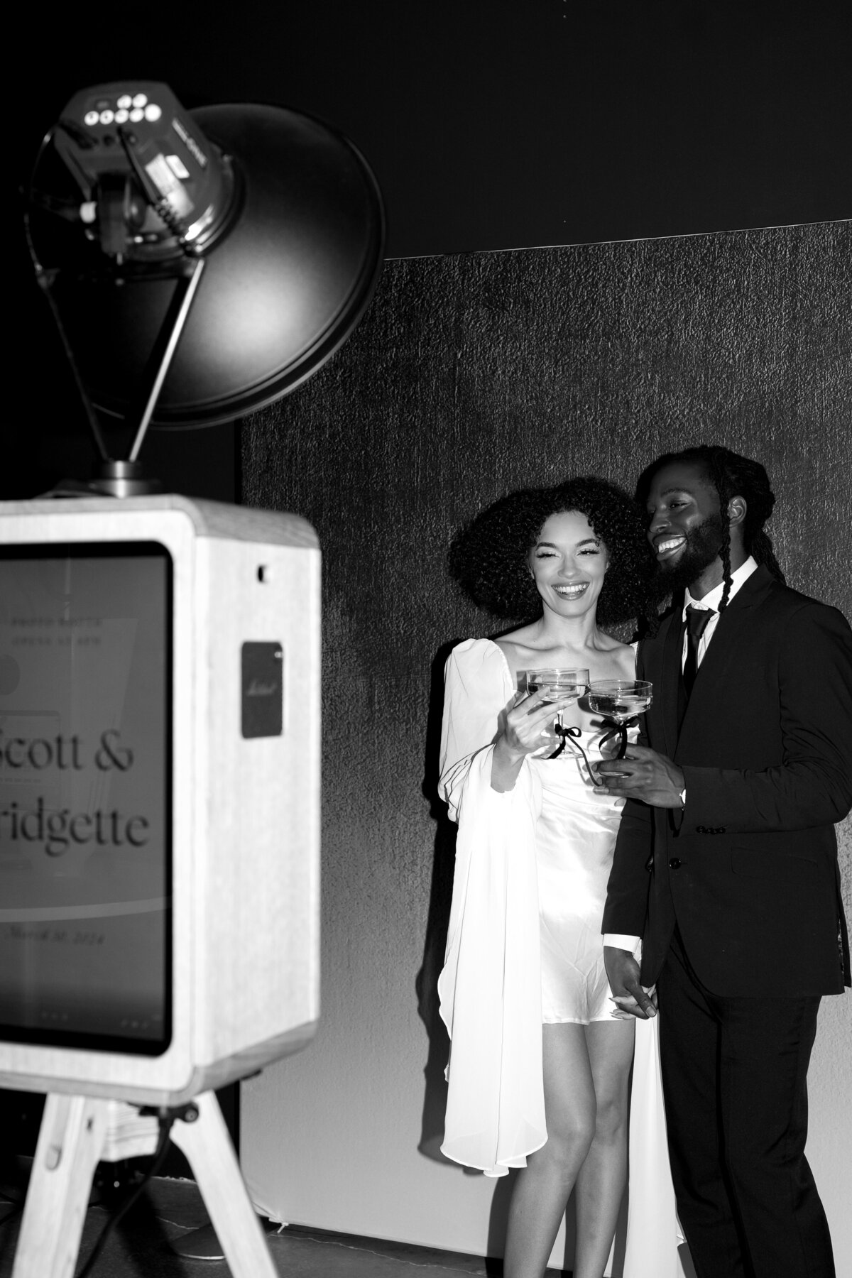 bride and groom using a photo booth