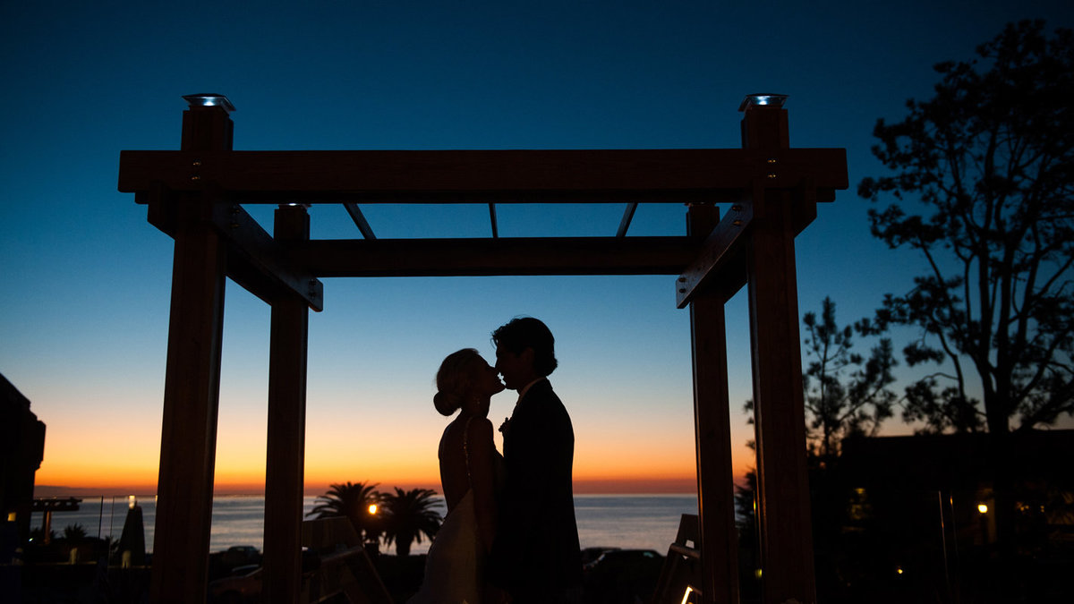 Couple-kiss-on-wedding-day-silhouette-at-Luberge-Del-Mar-CA-