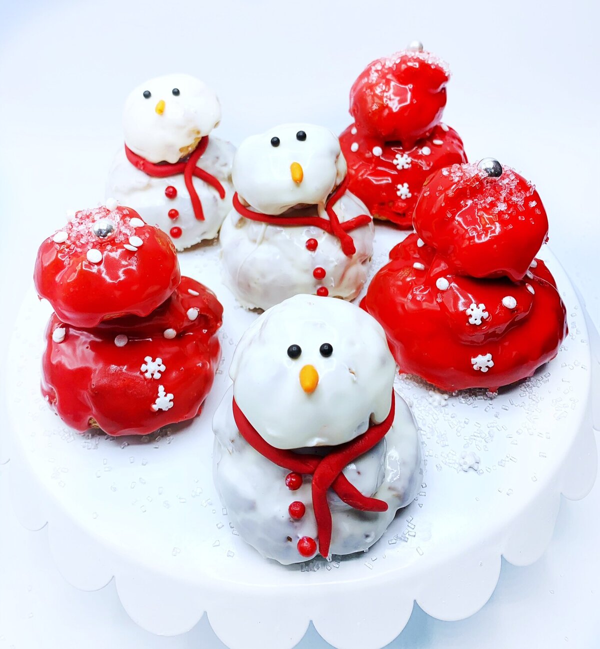 Religieuse cream puffs decorated as snowmen and red and white snowflakes