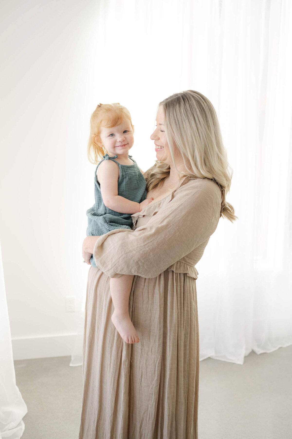 cute toddler being held by her oklahoma mother