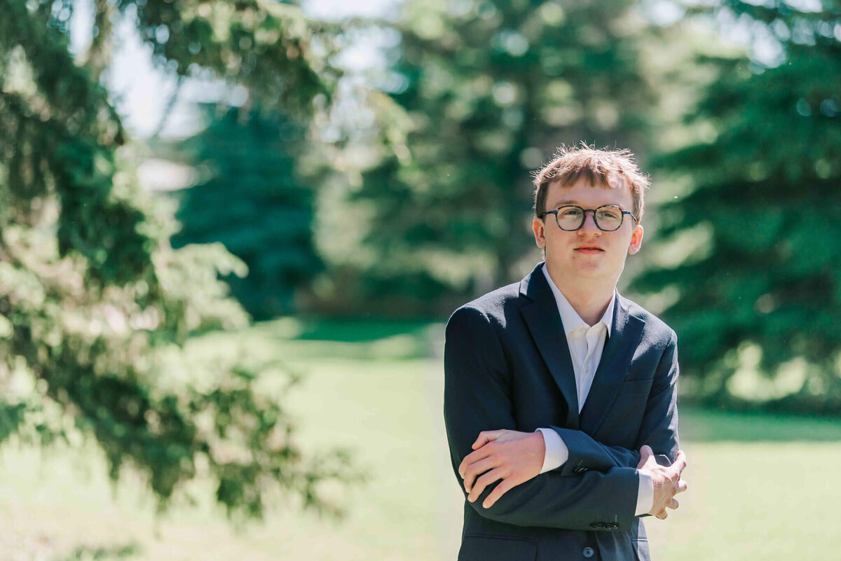 A handsome man standing with his arms crossed.