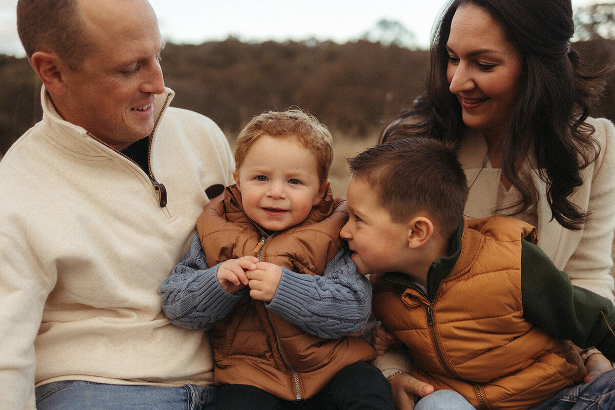 Mum with child smiling and bushland background