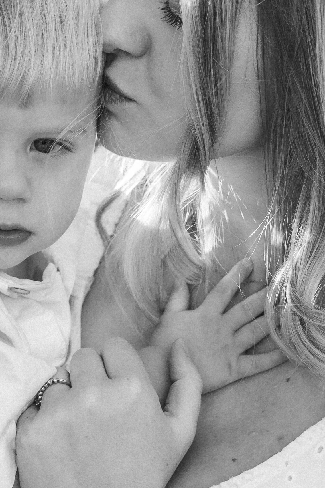 close up of a little boy being held by his mom