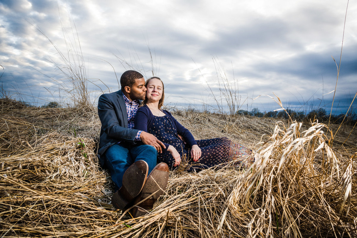 Mixed race couple kiss at sunset