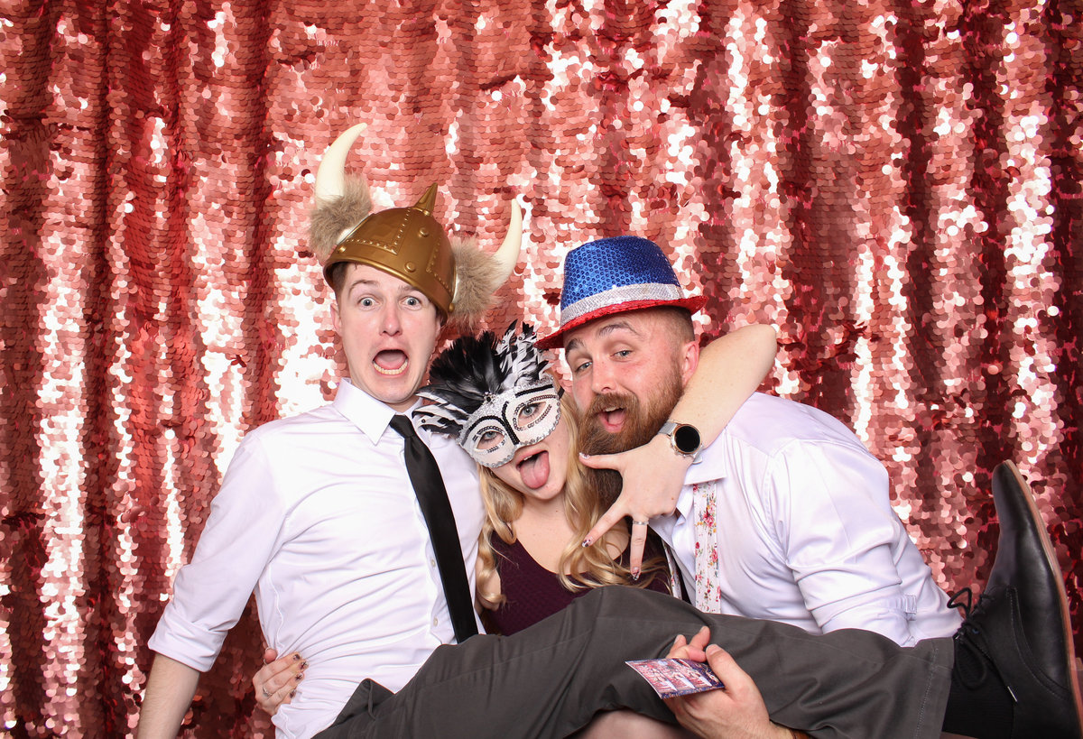 Wedding guests ham it up in a photo booth