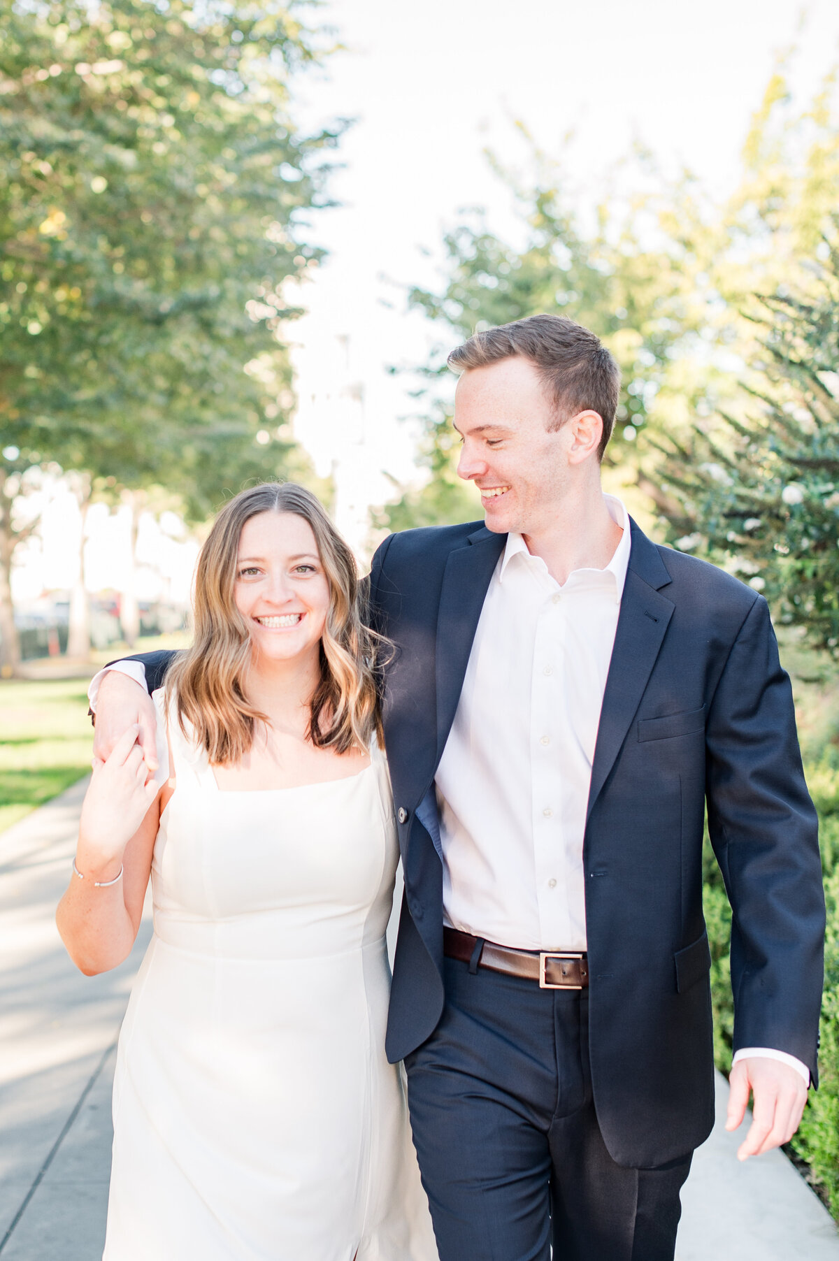 couple walking with arms over each other
