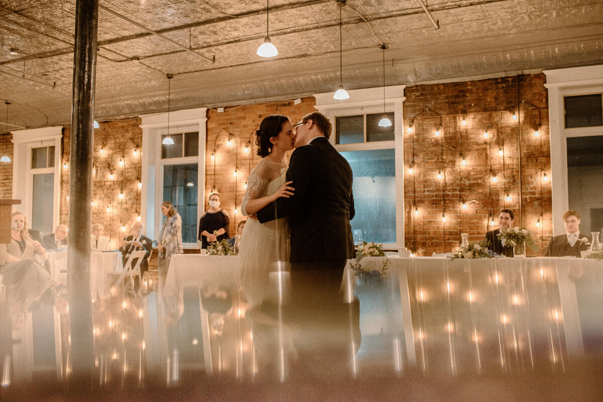 hamilton ontario spice factory wedding bride and groom kiss during twinkle lit first dance