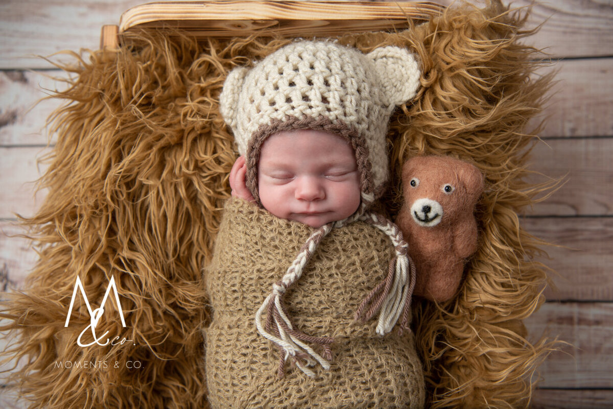 Baby-girl-in-brown-in-newborn-bed-with-bonnet-photo-5
