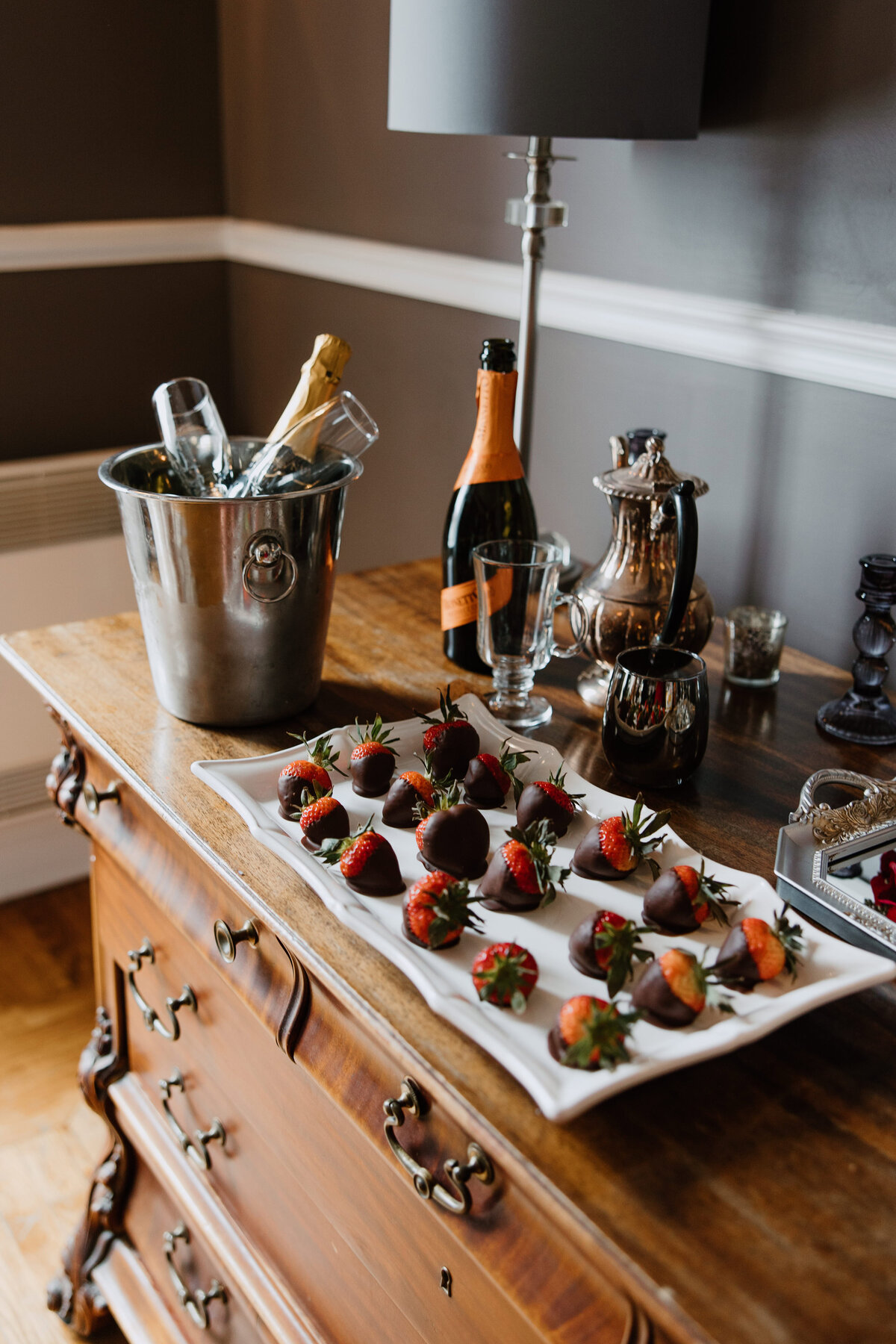 Close-up of chocolate dipped strawberries and alcoholic drinks