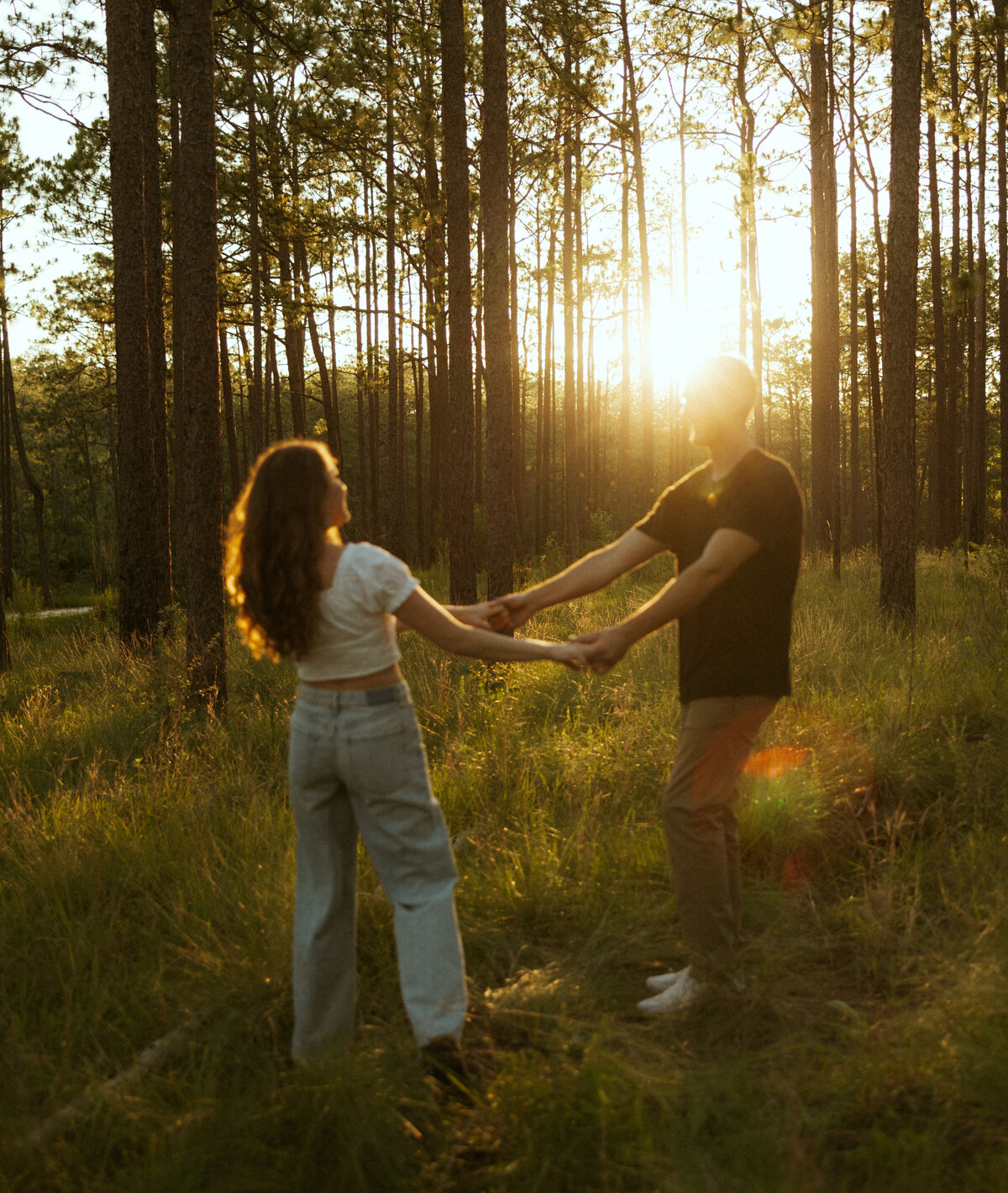 Couple posing for portraits in a forest.