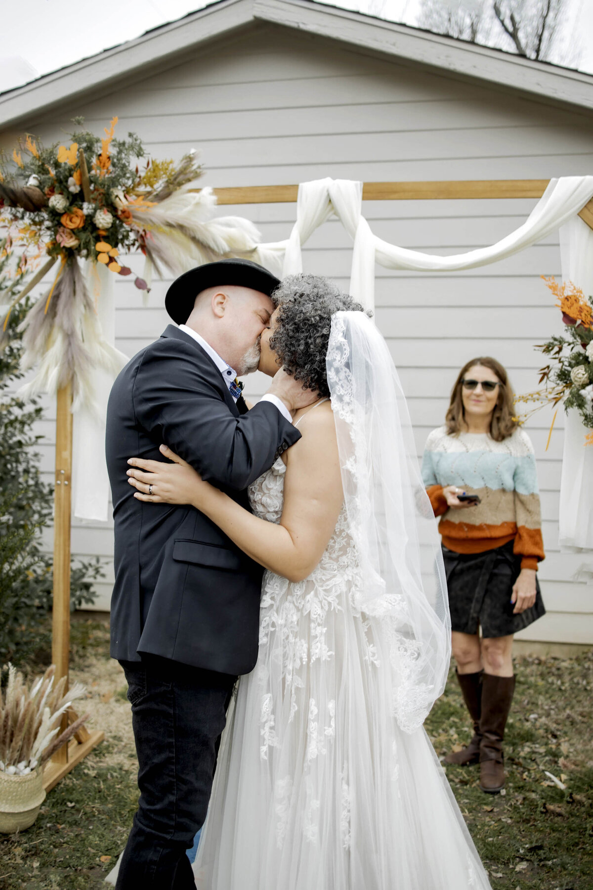 a married couple share a kiss at their micro wedding in dallas