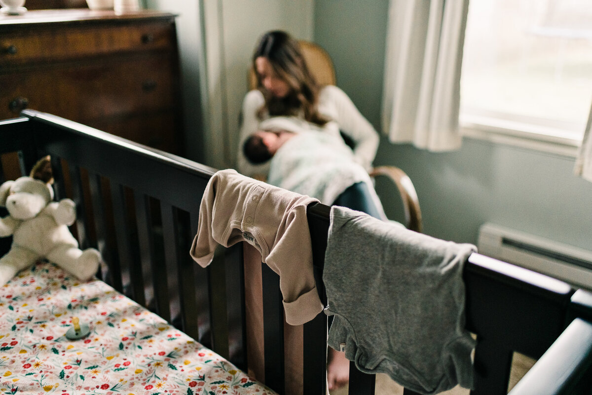 Mother with Baby in nursery at lifestyle newborn photos