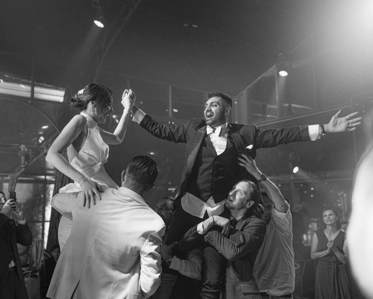 Bride and groom in the air on dance floor at Lake Como wedding