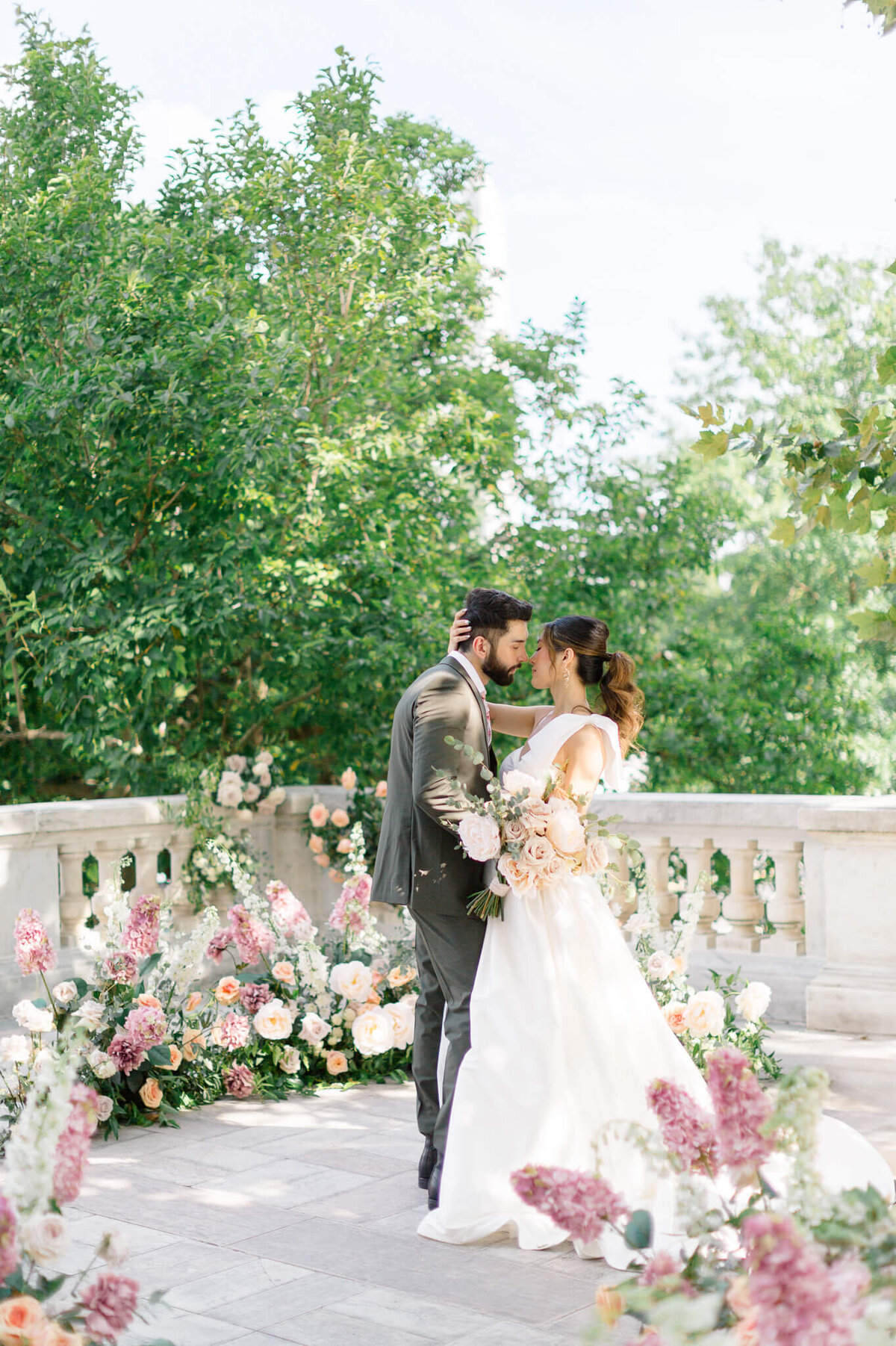Bride and Groom kissing on the portico at DAR Constitution Hall. Captured by Washington DC Wedding Photographer Bethany Aubre Photography.