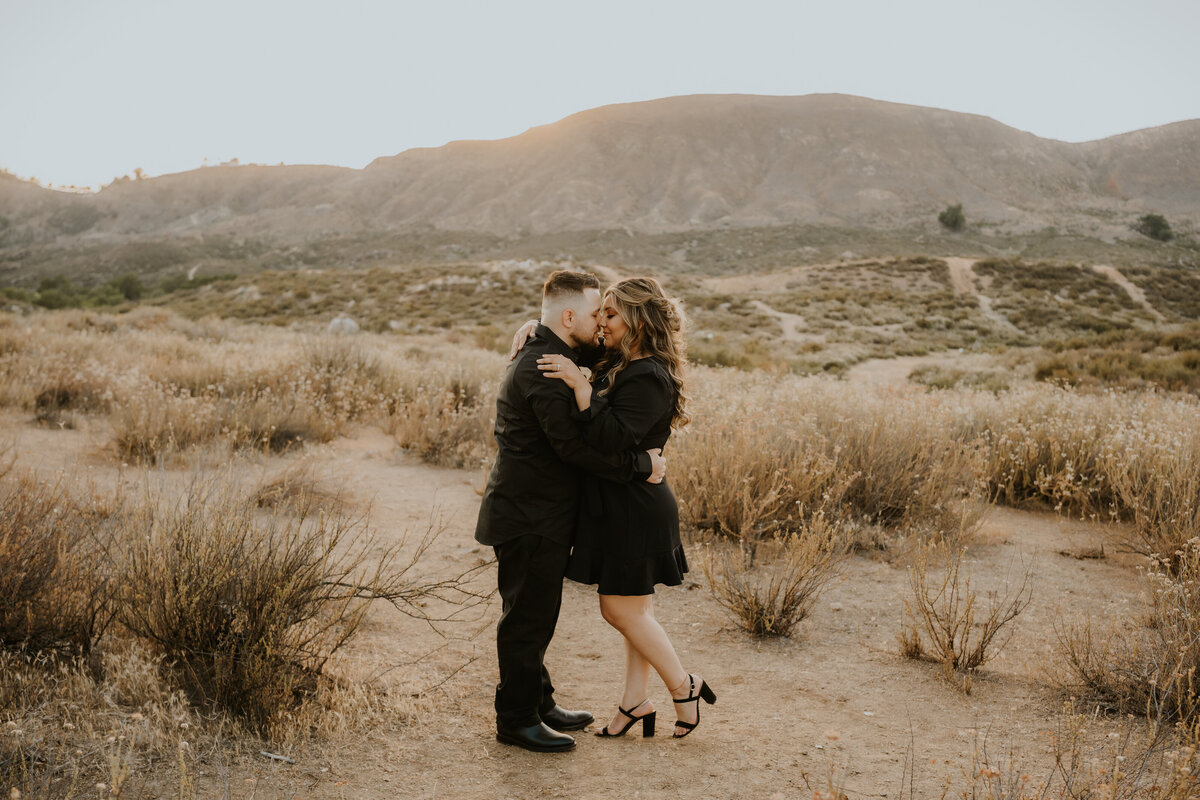 Man and woman in desert kiss