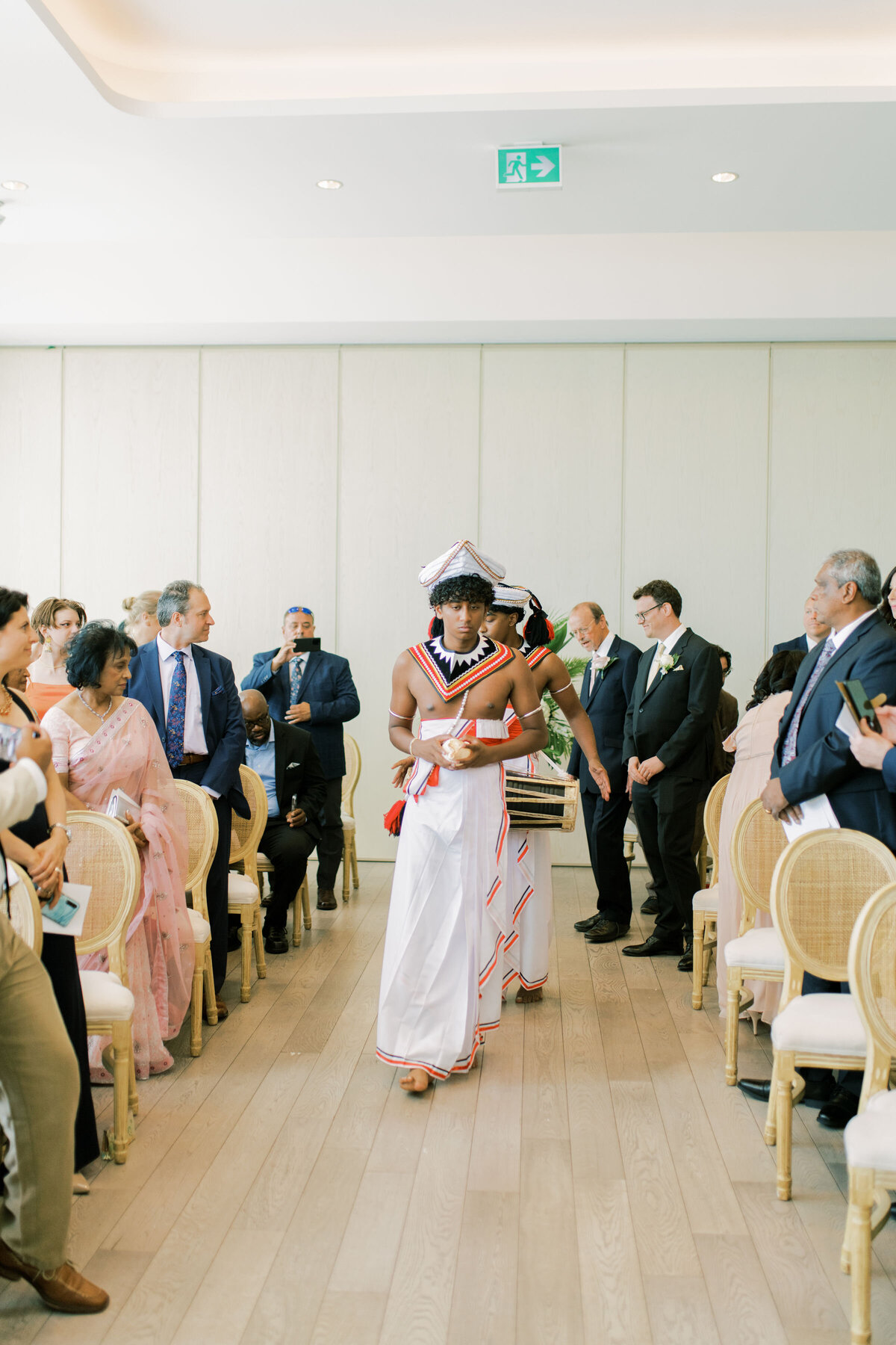 Walking down the aisle at the pearle hotel with drums at an indian wedding