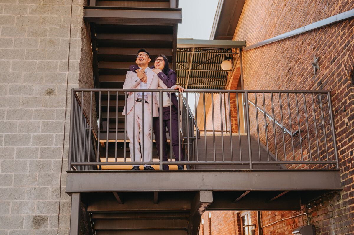 A couple hugs one another on a stairwell