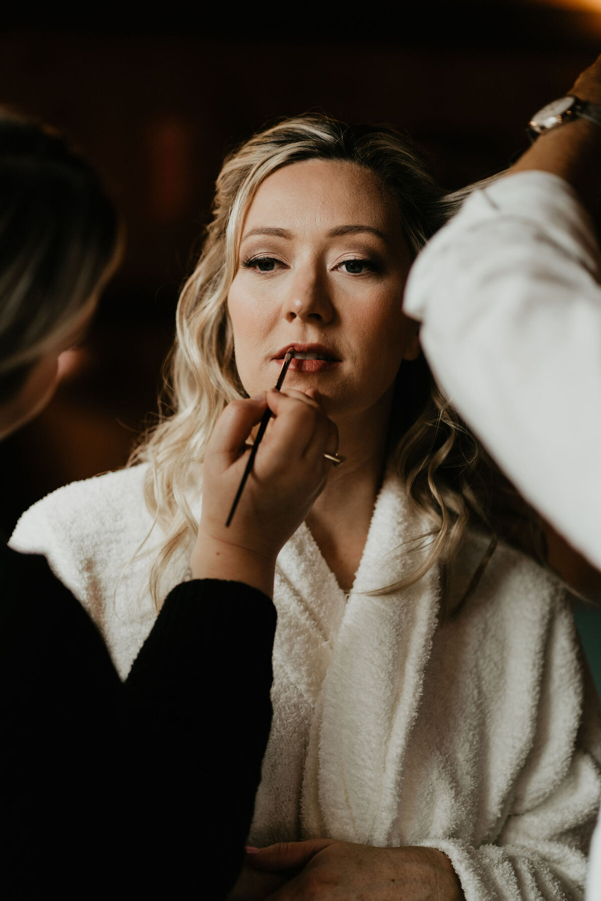 Bride getting her hair and makeup done