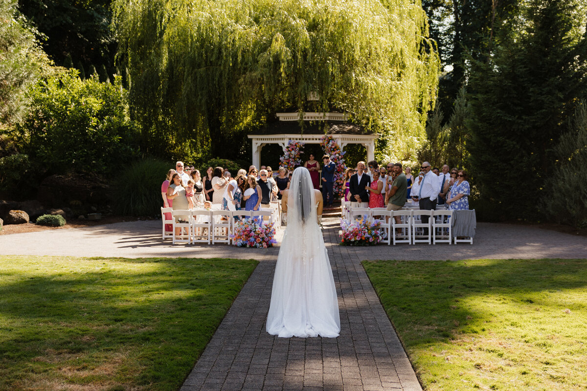 cenic wedding venue with rose-lined aisle and white gazebo at the Abernethy Center in Oregon