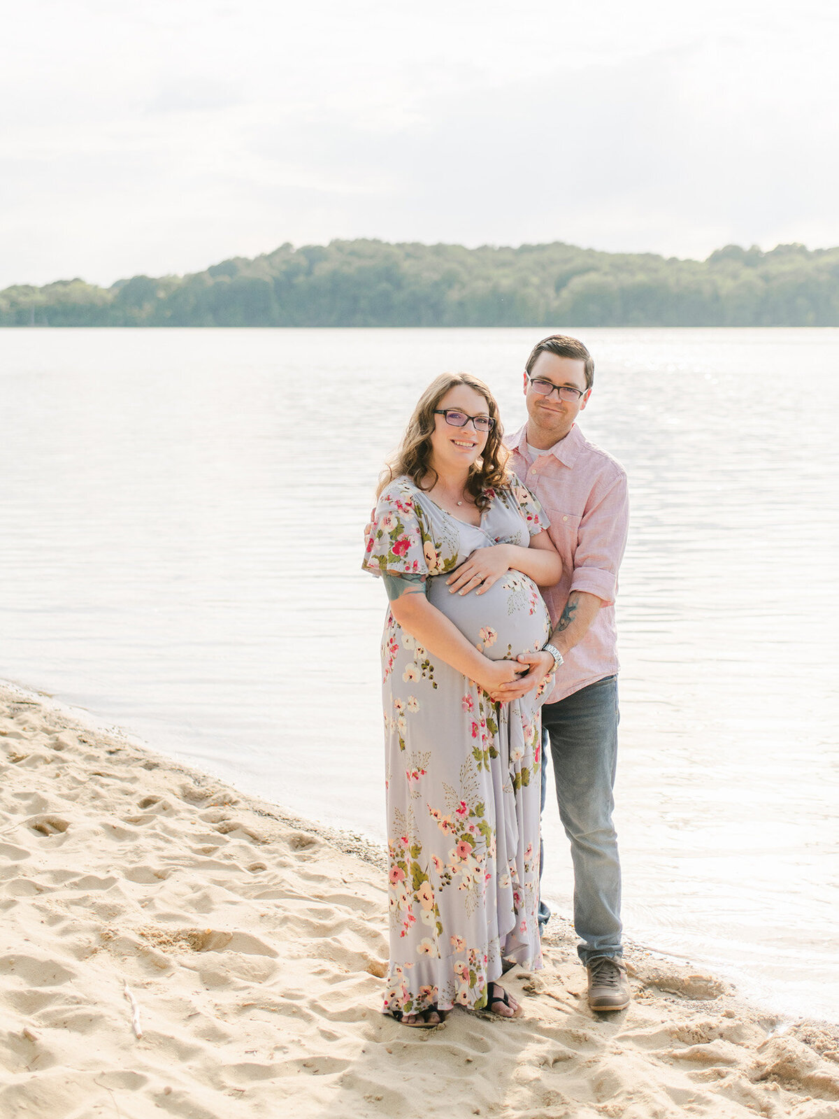 Expecting parents during a maternity beach session.