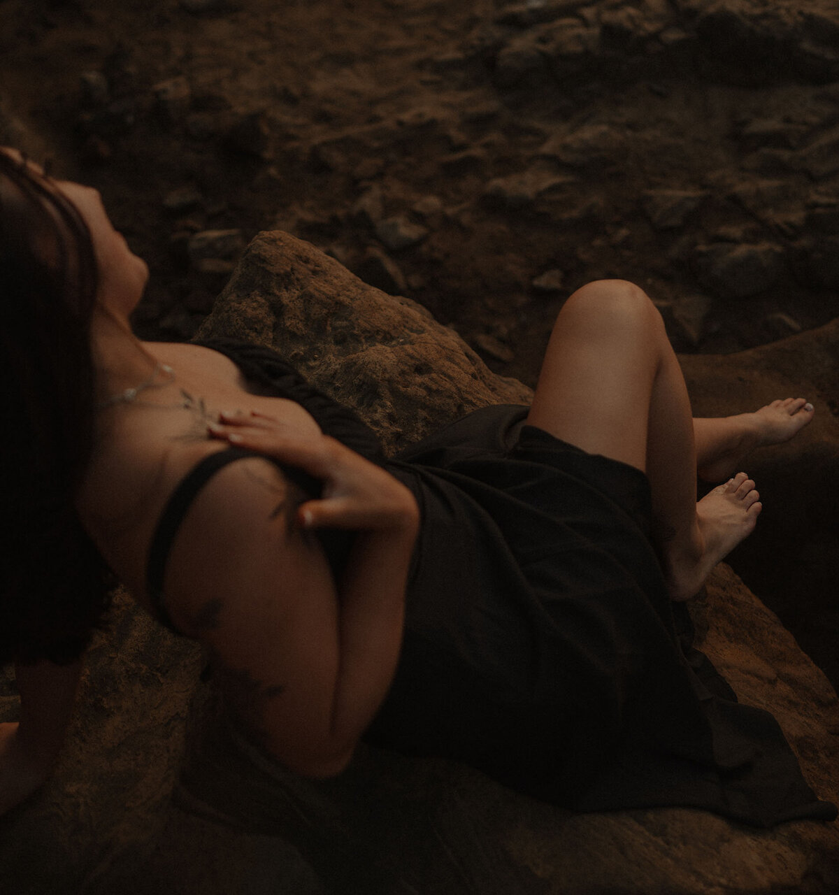 intimate close up of a woman wearing a feminine black dress at the Oregon Coast