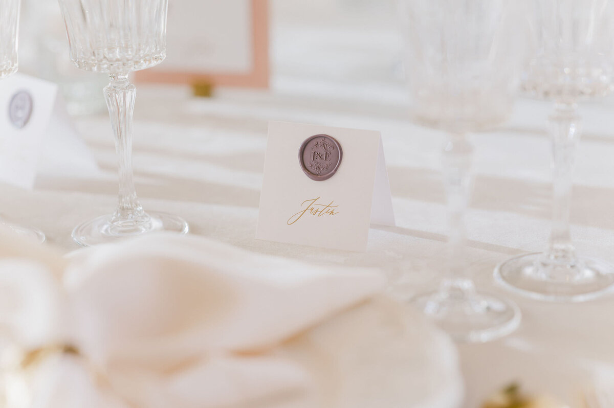 Elegant pink and white place settings and name cards at wedding reception