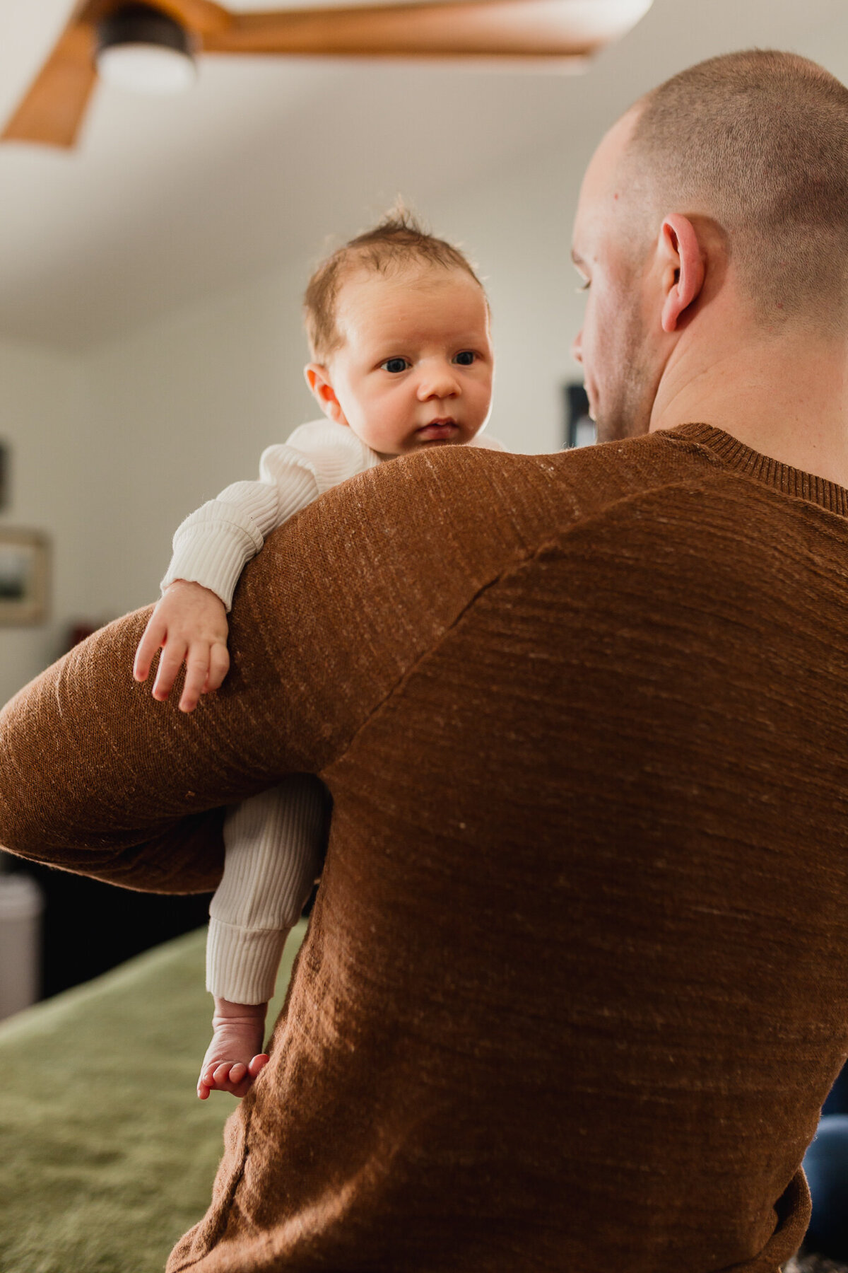 Family Photoshoot Session with mom, and dad holding newborn baby.