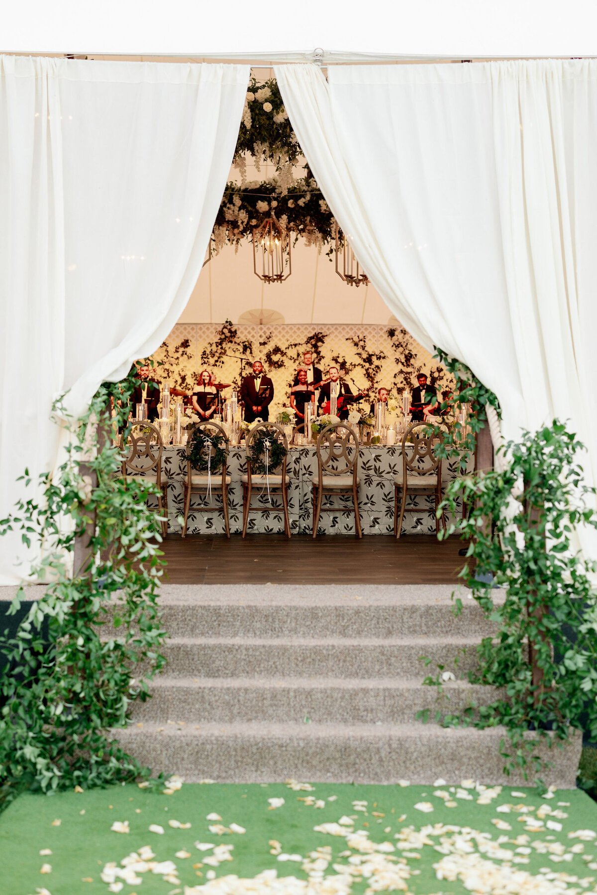 A zoomed out photo of the wedding tent with the reception inside.