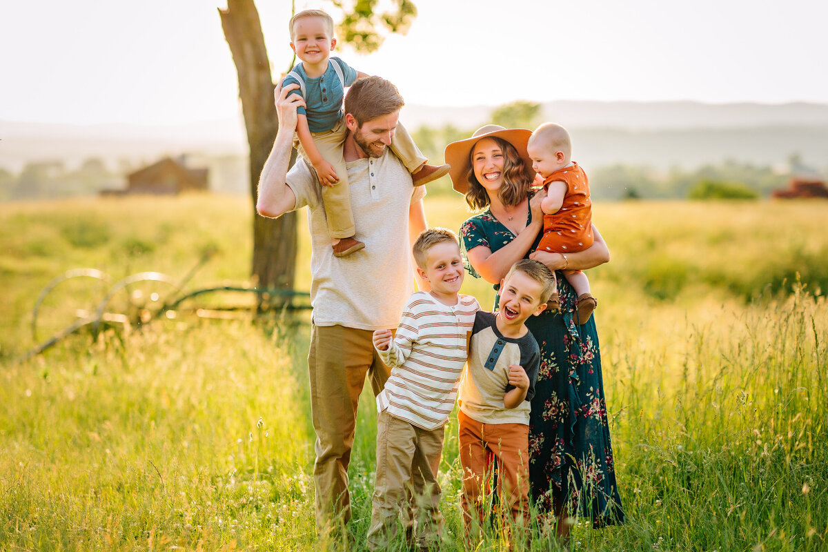Family laughing in a field family portraits near Harrisonburg, VA
