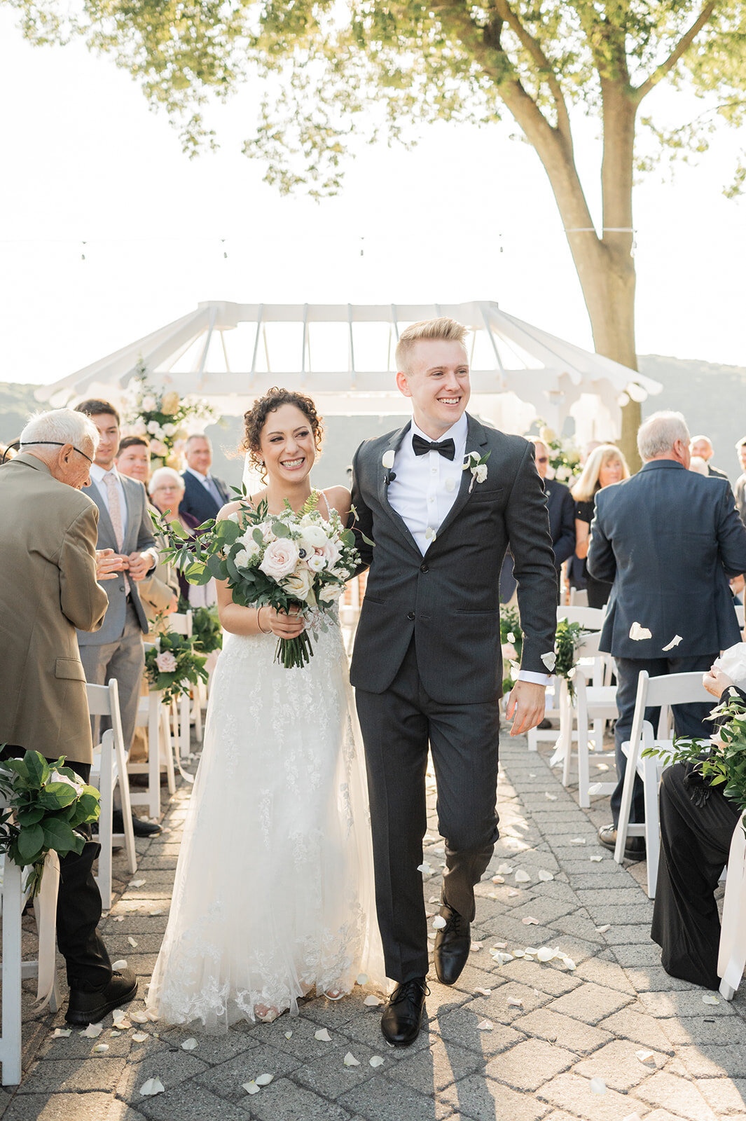 couple walks out of ceremony all smiles in poughkeepsie wedding