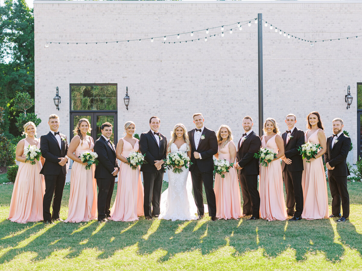 open air patio with bridal party in pink