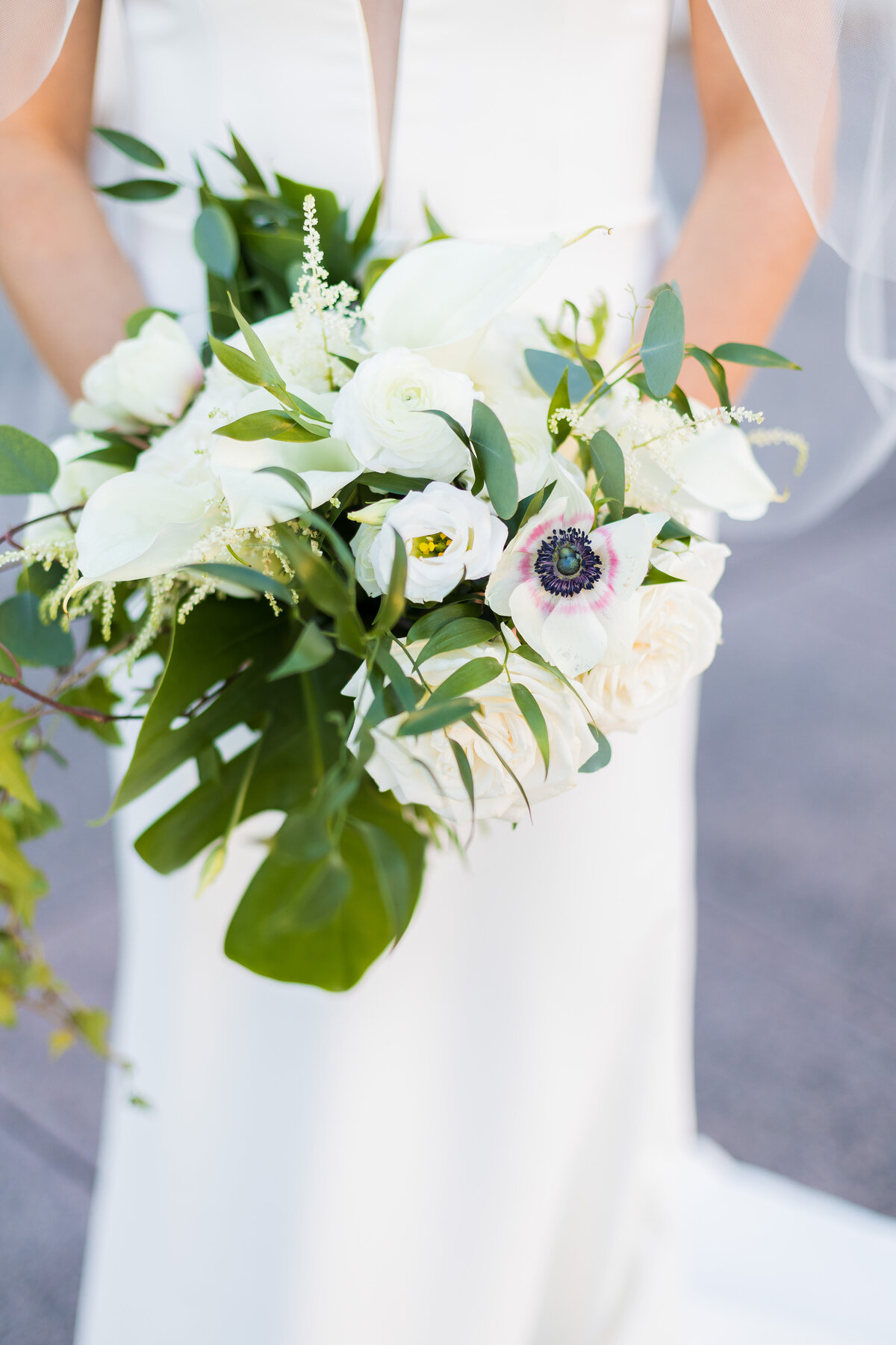 Bride holding bouquet of white and green florals at Tennessee State Museum