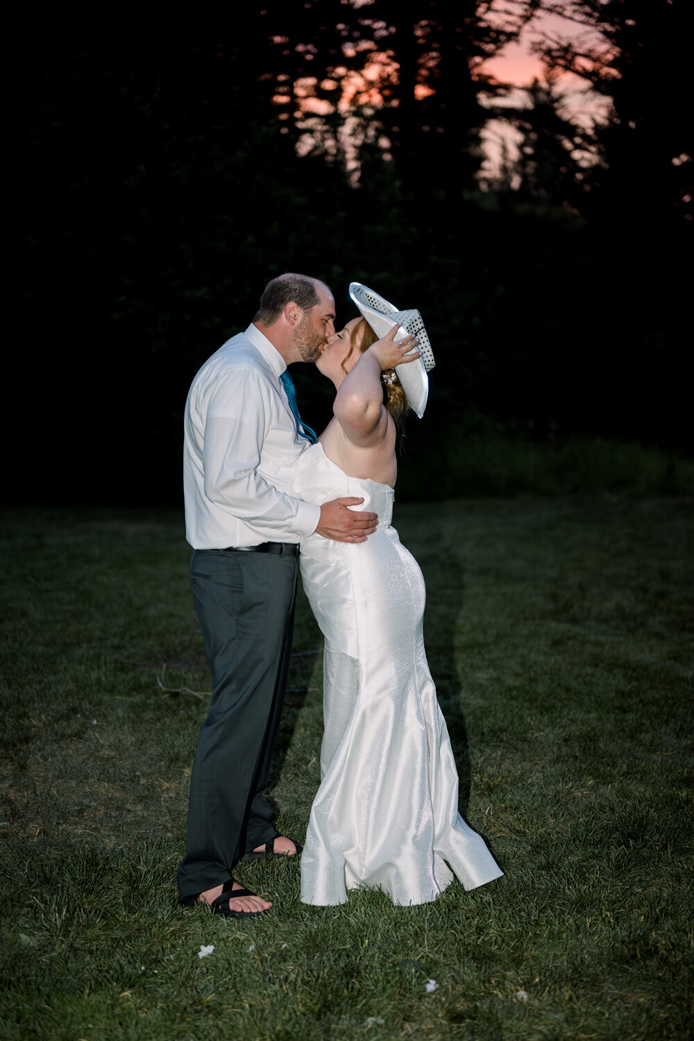 Bride and groom sharing a kiss under the night sky during their Montana summer wedding.