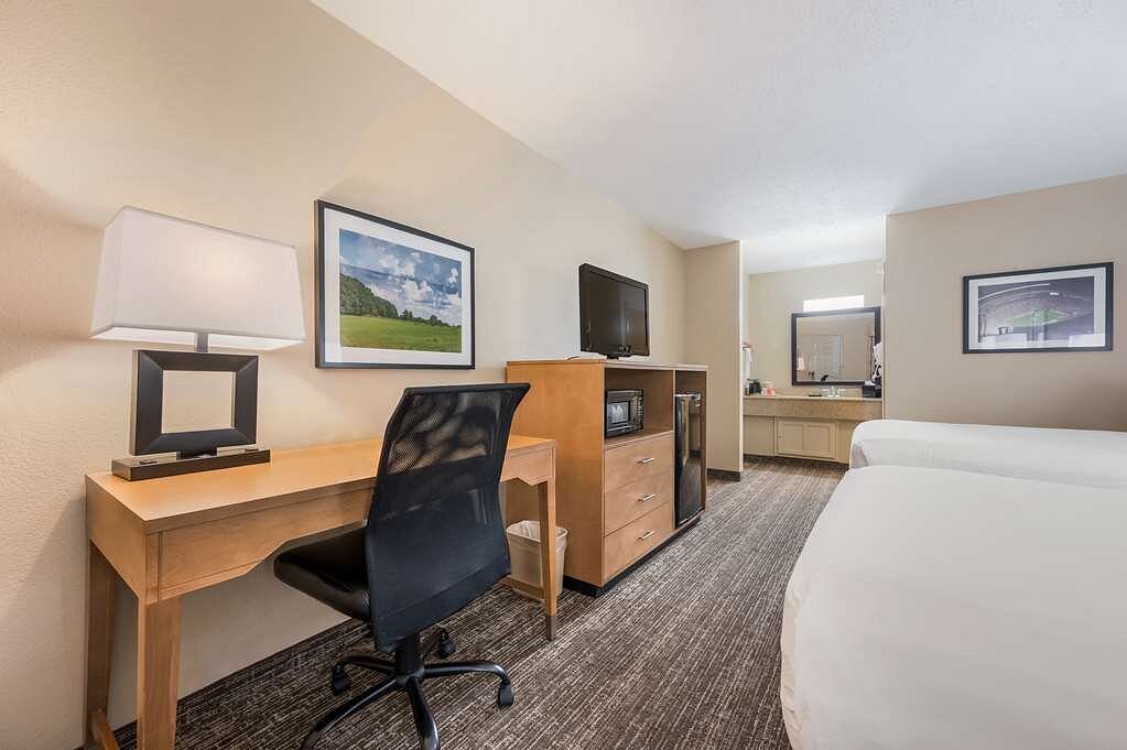 Hotel double queen guest room with view of desk