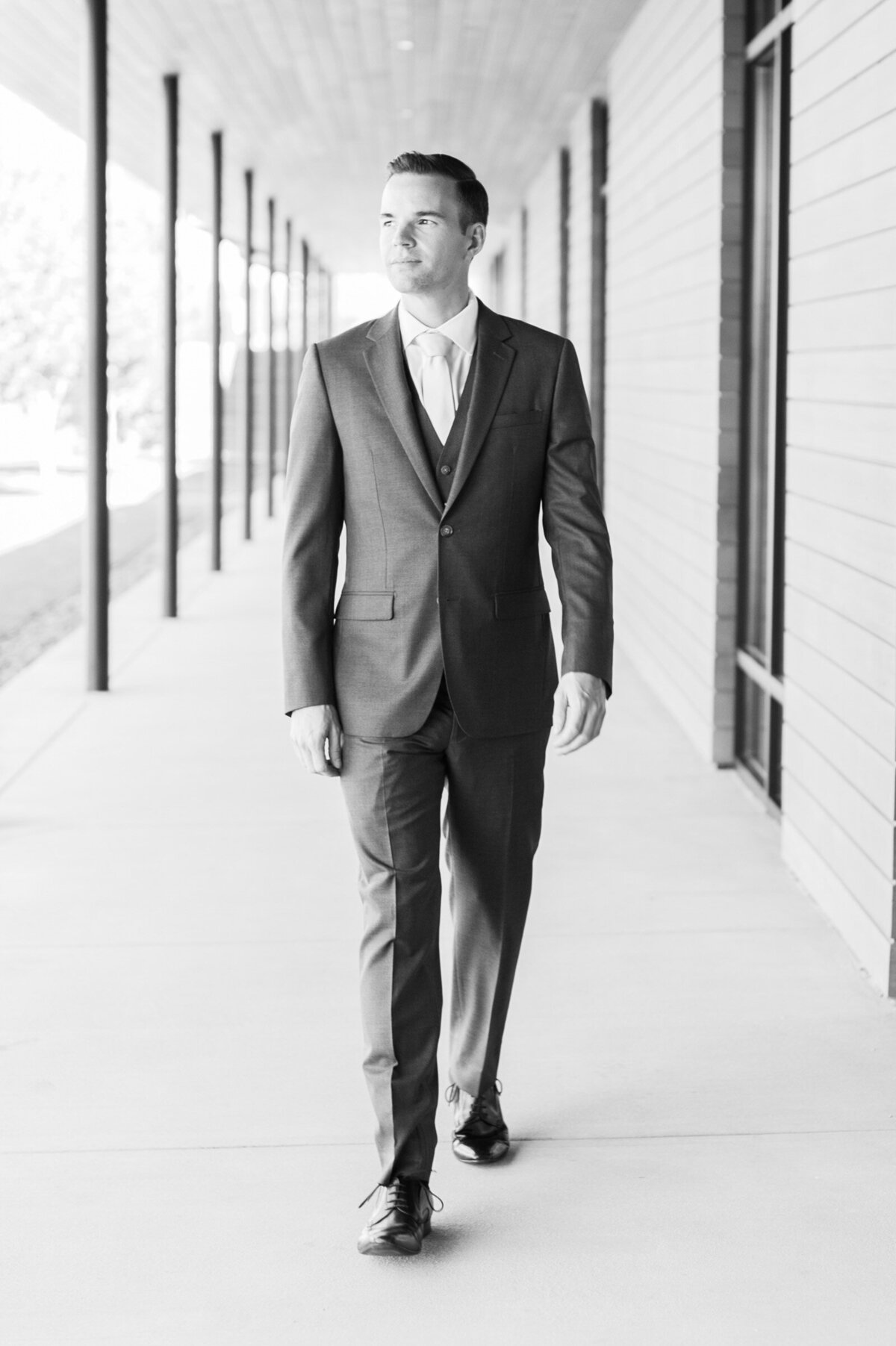 groom walking down walkway at ponzi vineyards