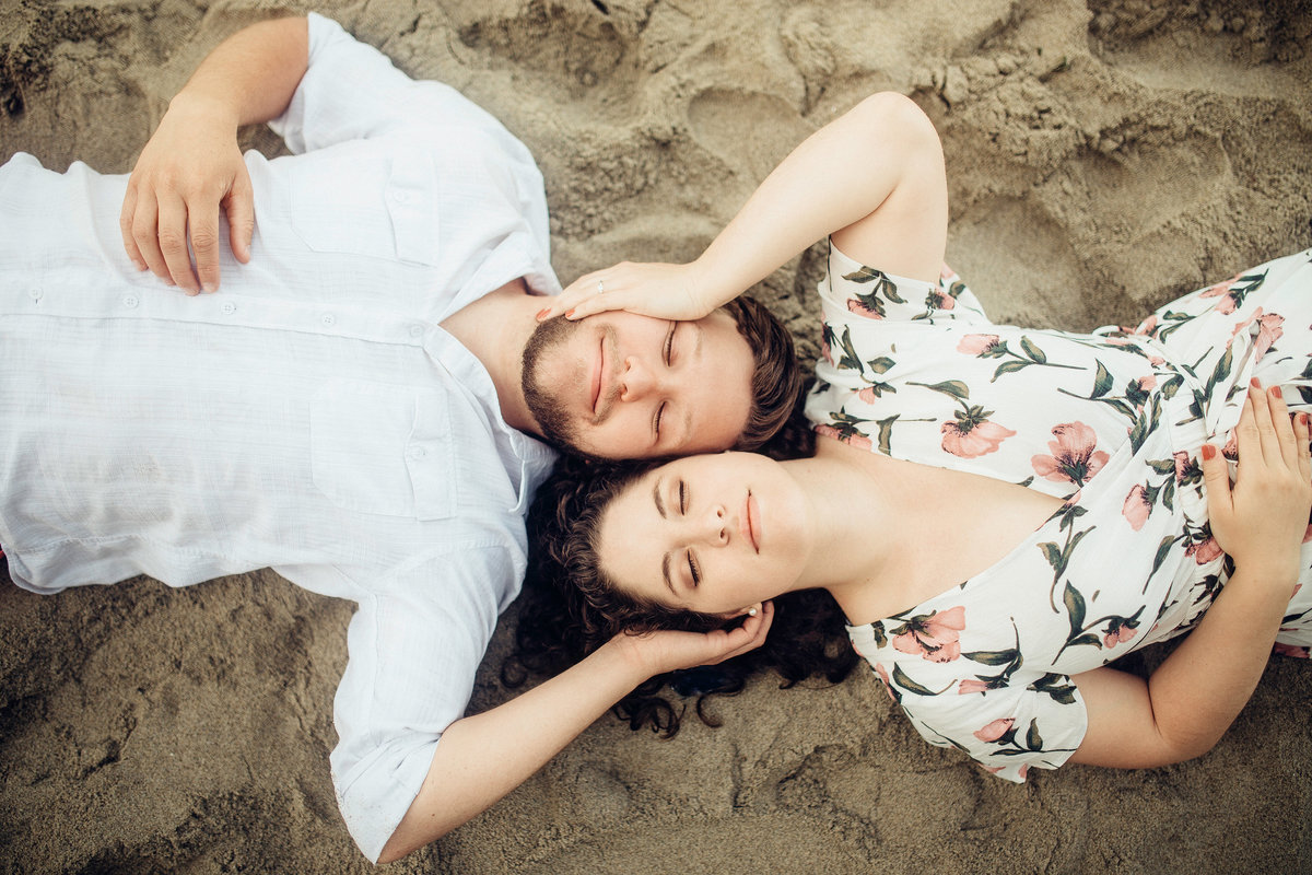 Engagement Photograph Of  Man And Woman Laying On The Sand Los Angeles